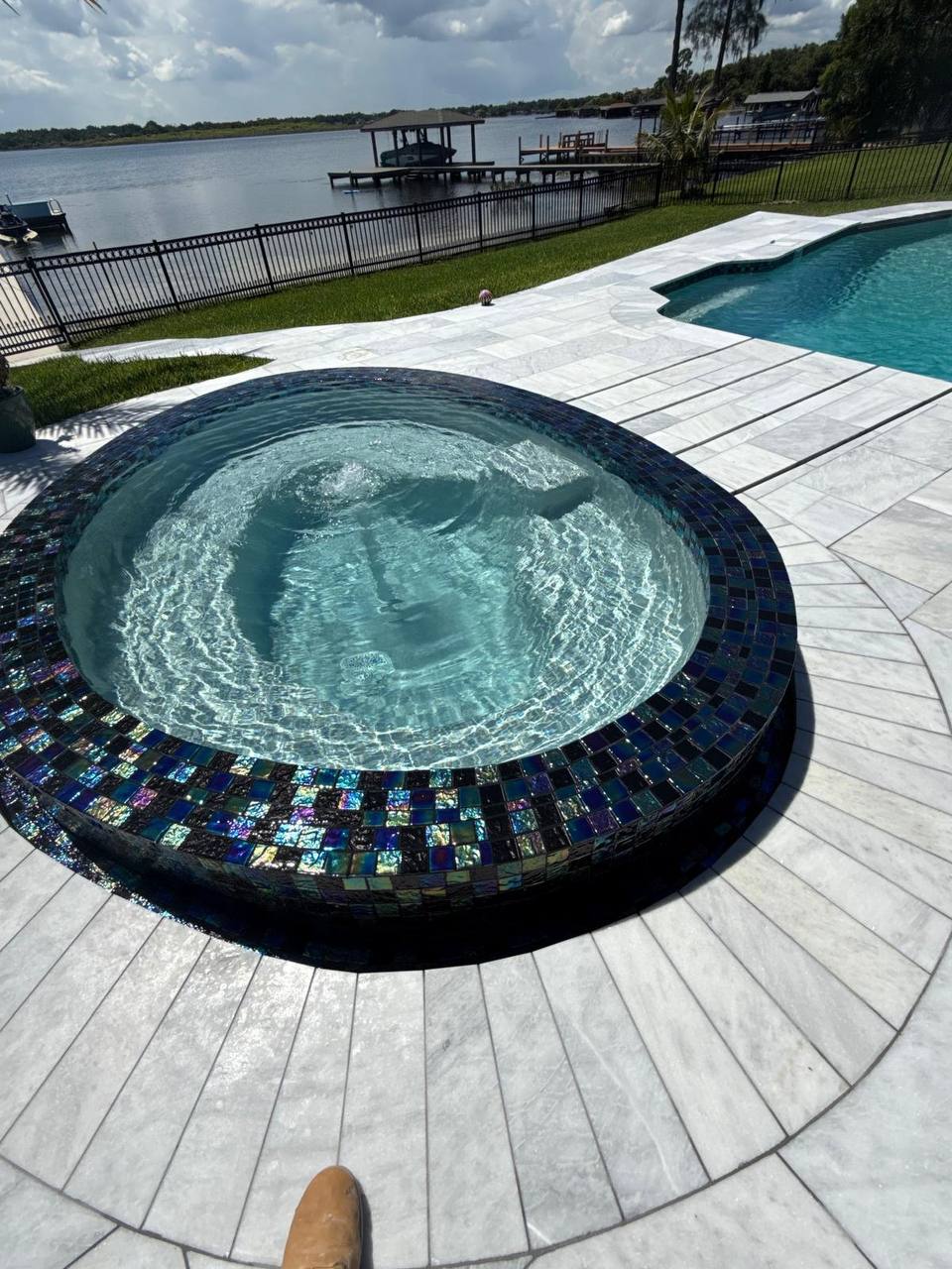 Stunning renovated spa with iridescent blue tile work and modern decking